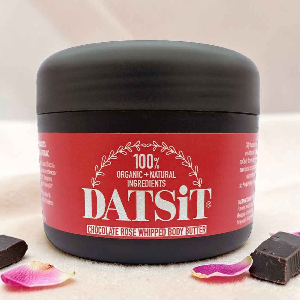 organic whipped body butter jar chocolate rose 150ml Datsit with soft shadows and pieces of chocolate and rose petals on the table surface