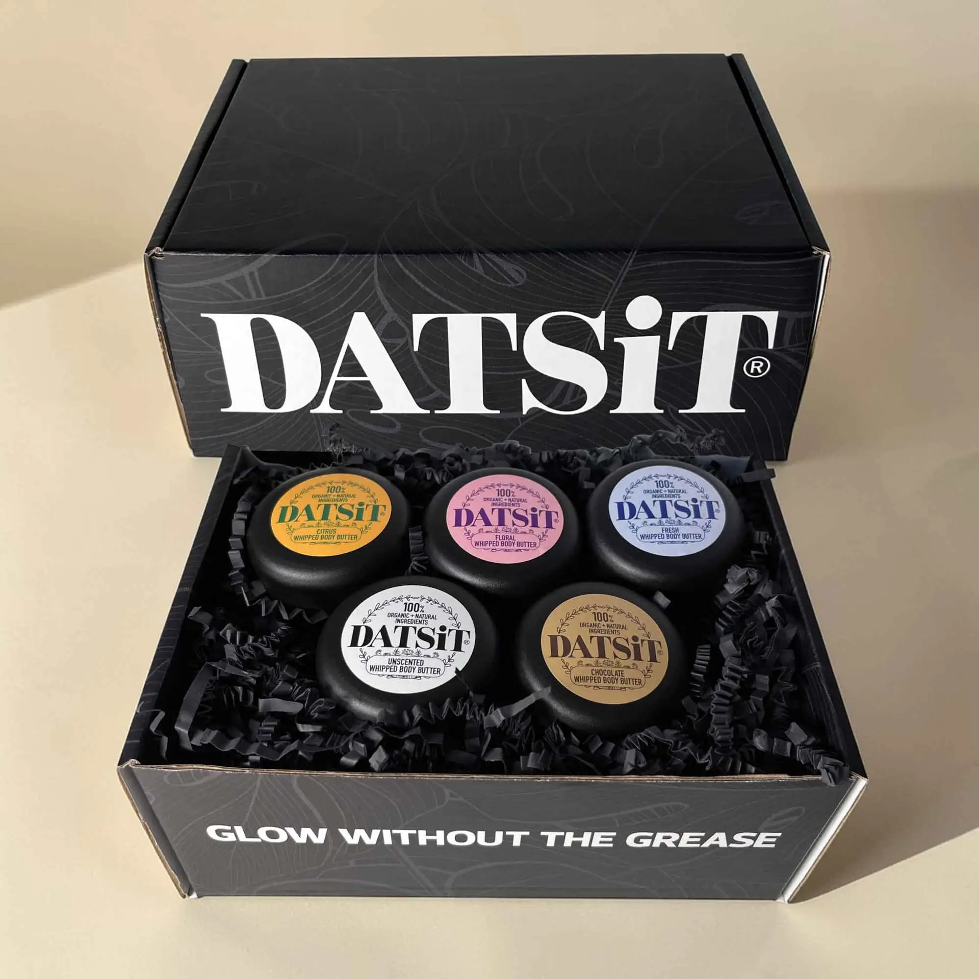 A box of the Datsit discovery pack containing five 50ml jars of organic body butter